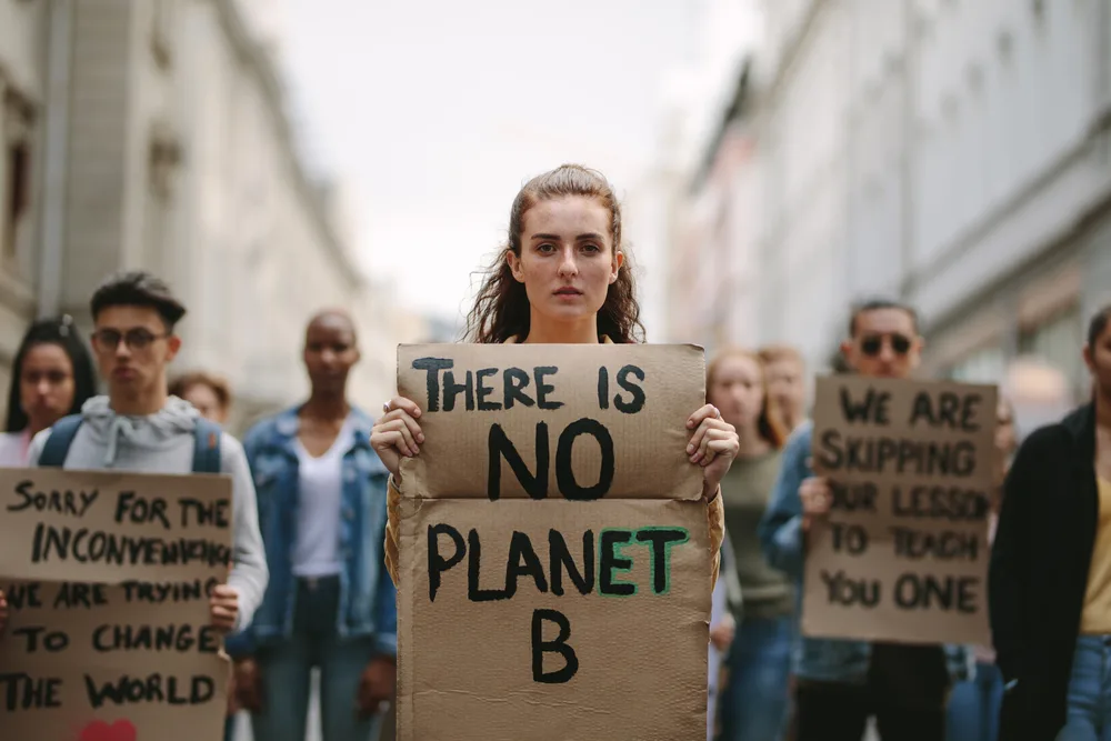 Young lady protesting in street about climate change