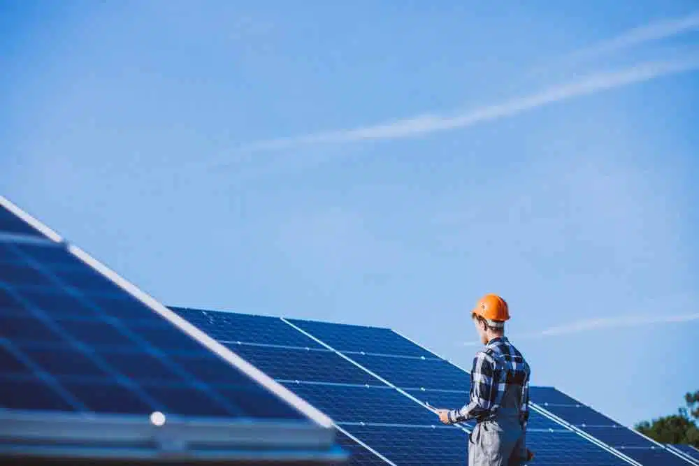 How to Choose the Right Solar Panel System for Your Home Man in Field looking at the best solar