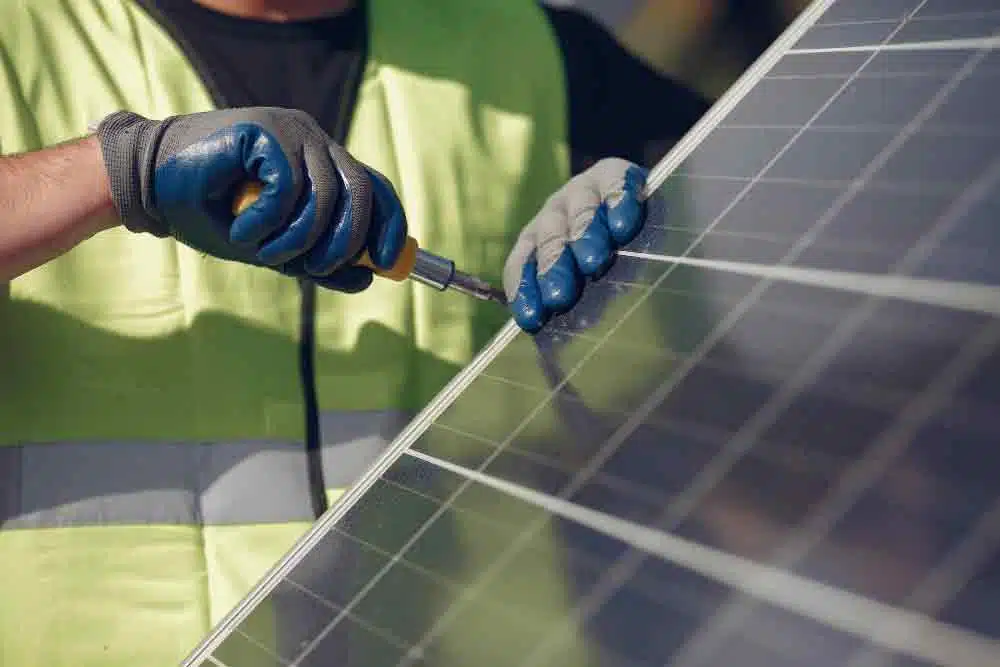 man with white helmet near solar panels in South Wales