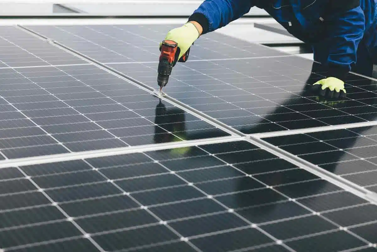 man checking the reliability of the solar panels