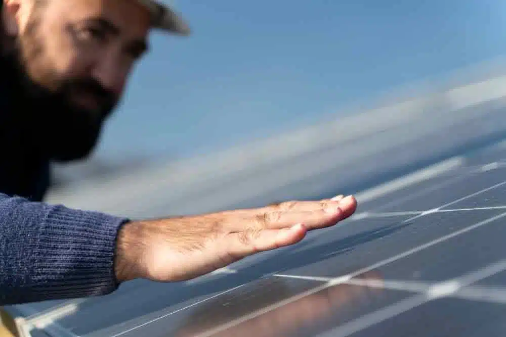 Solar Panels and Battery Storage in Cardiff man inspecting panels