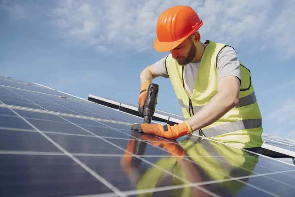 man maintaining his solar panels